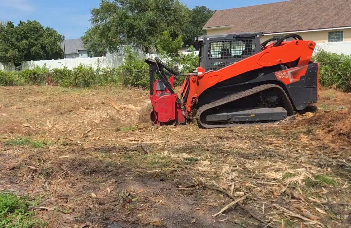 Kubota SVL 97-3 forestry mulcher clearing underbrush on a Jacksonville FL residential lot — 904Tree