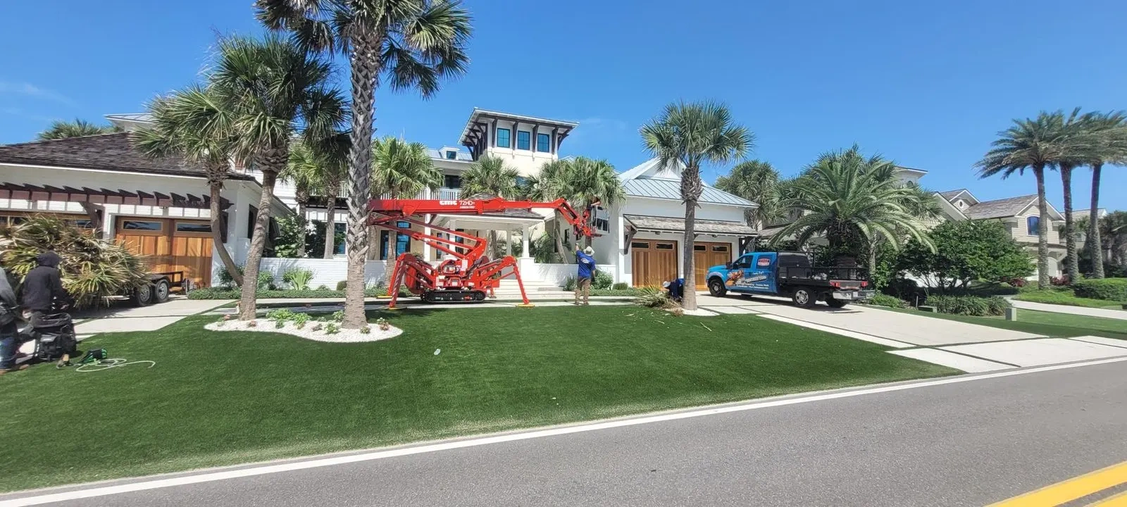 904Tree crew removing a tall pine from a compact spider lift in Jacksonville FL